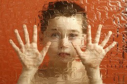 Boy behind wavy glass
