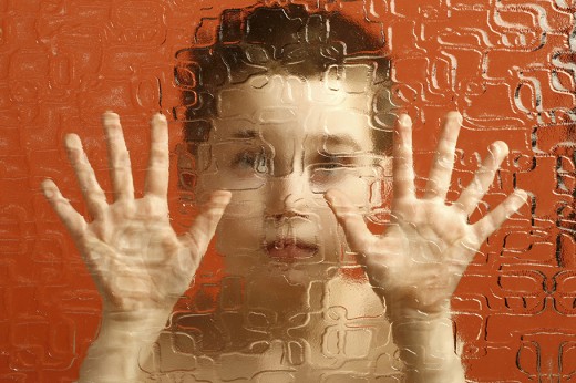 Boy behind wavy glass