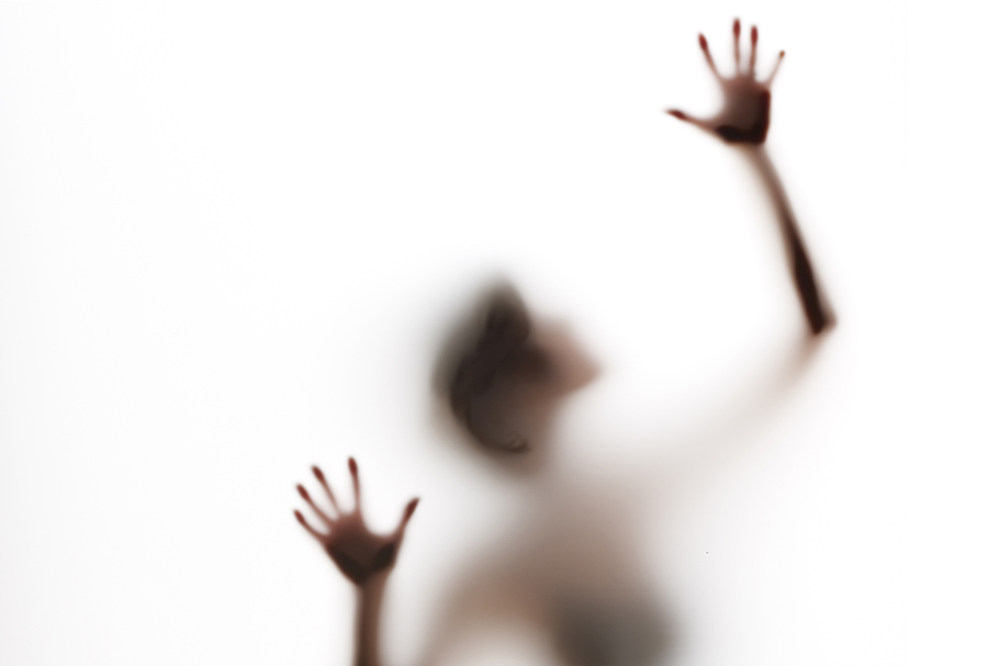 semi-obscured figure with arms raised