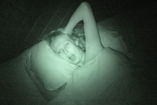 Woman screaming in bed at night